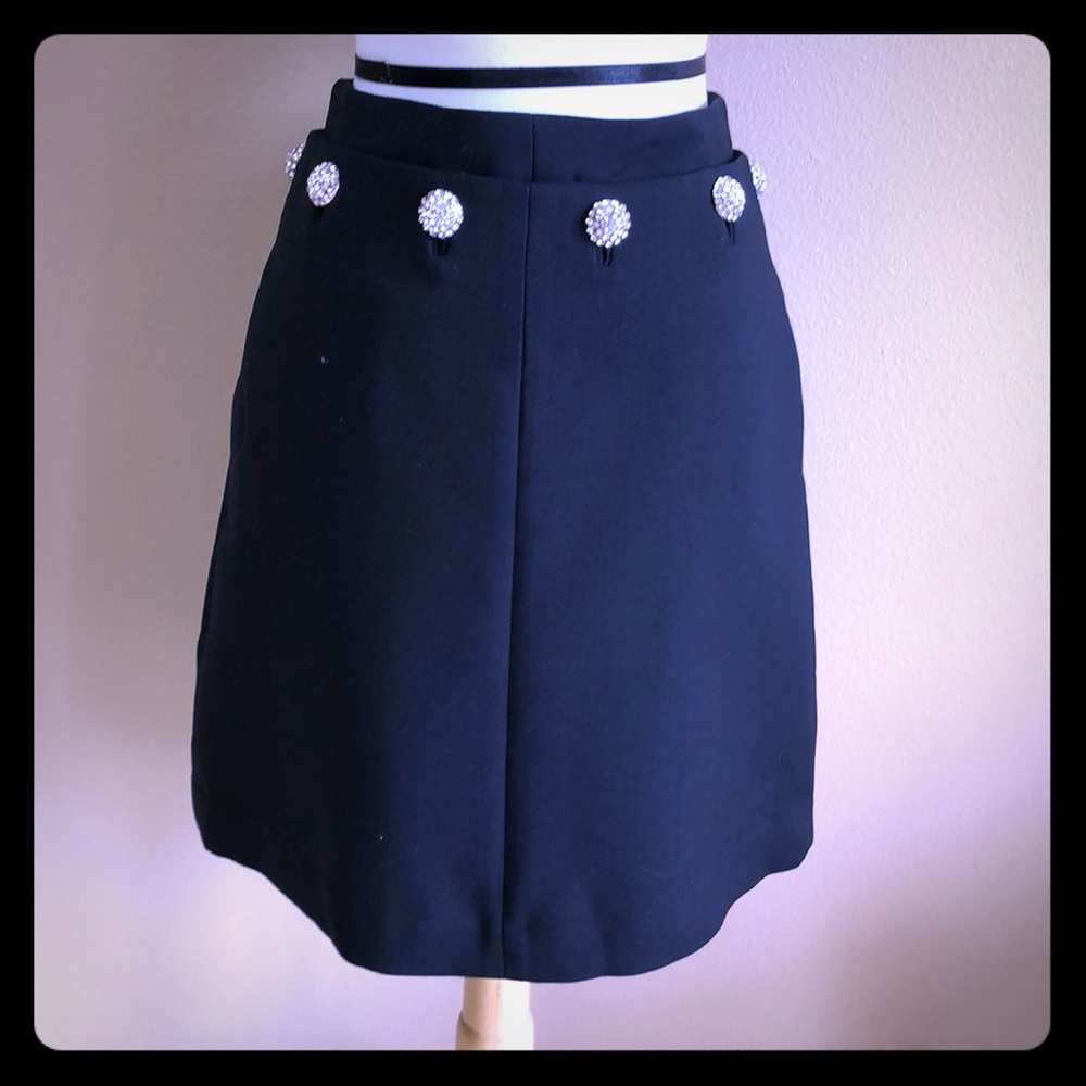 Black skirt with rhinestone buttons.